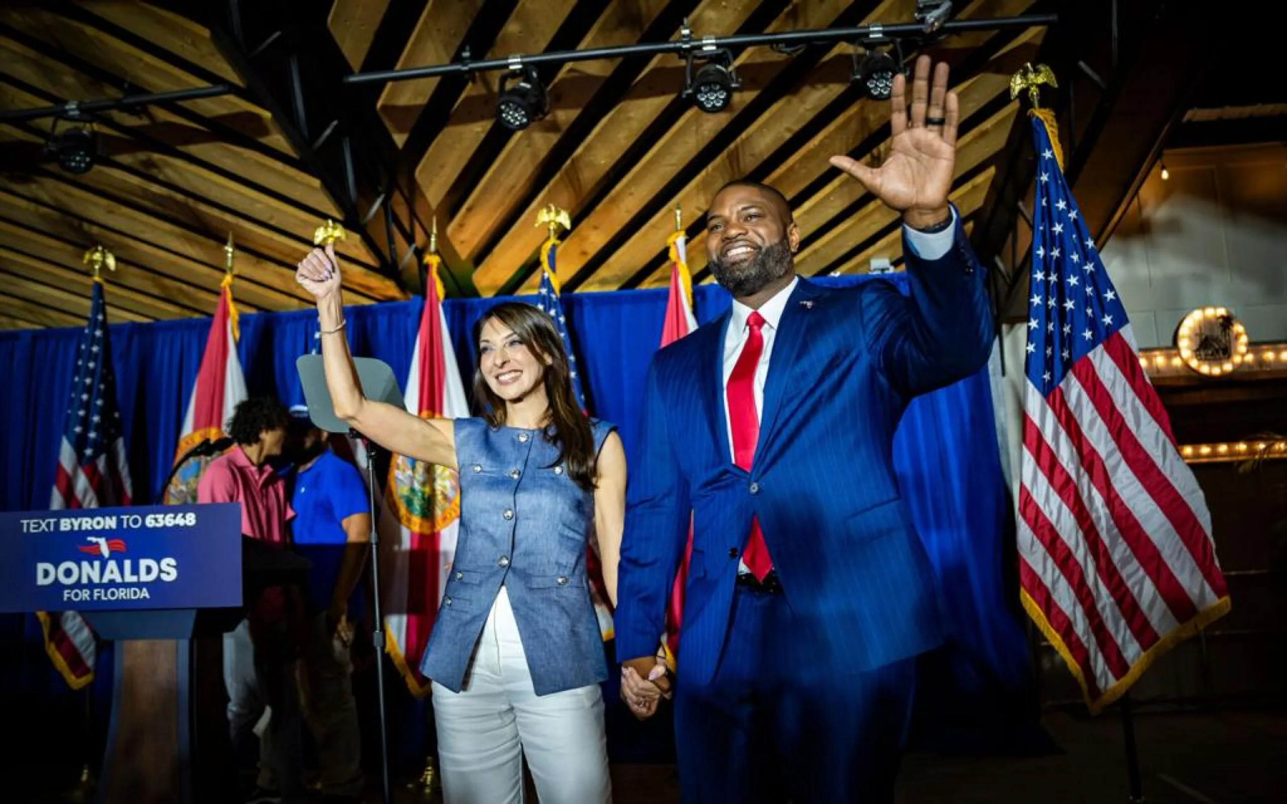 Byron Donalds and his wife Erika waving at a Florida campaign rally